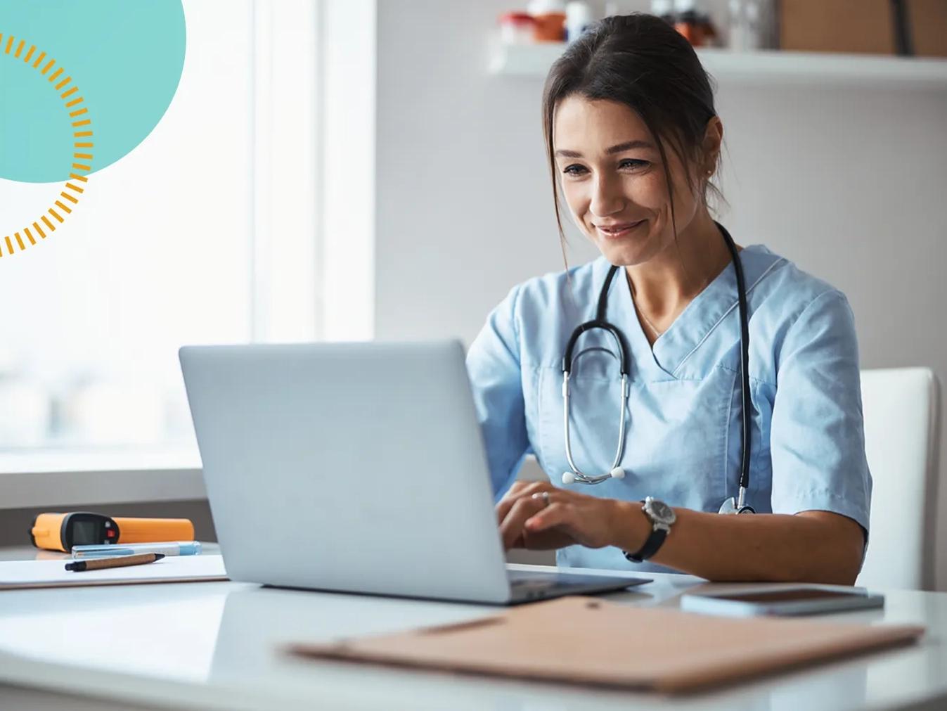 healthcare worker smiling at laptop