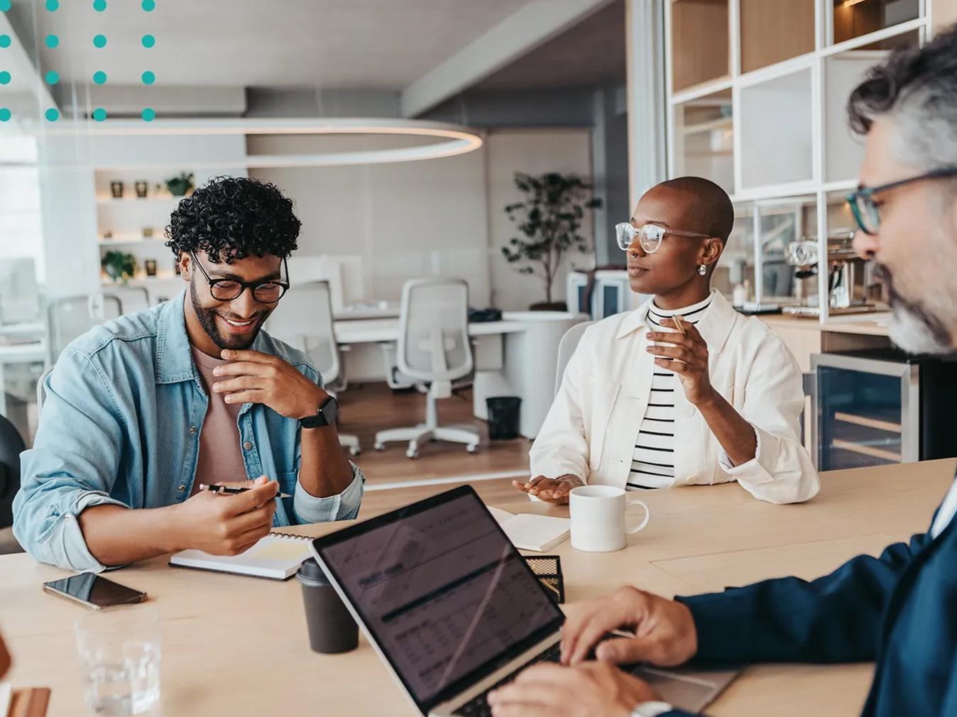 three people working together around a conference table