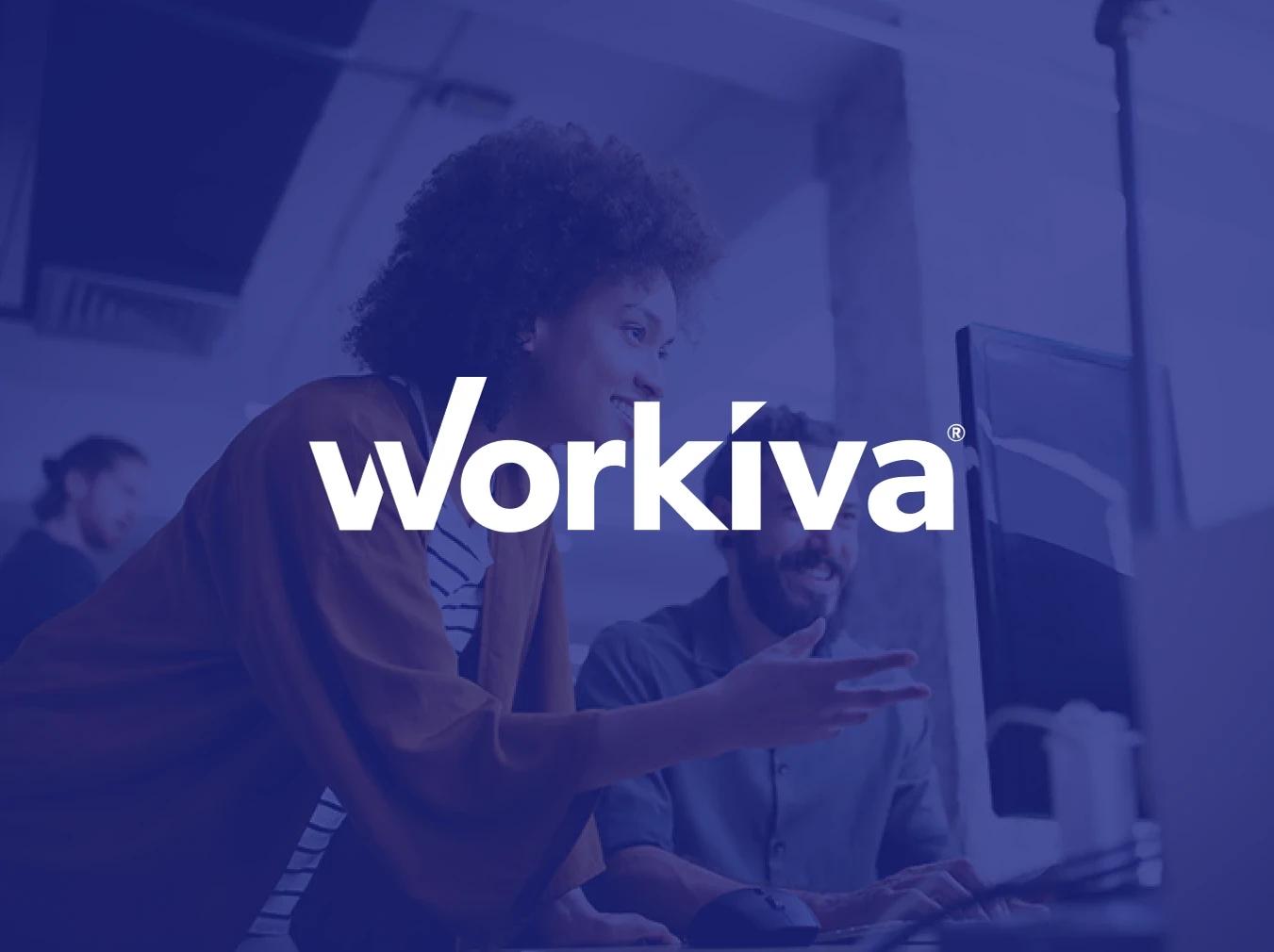 Logo for Workiva, a Business Wire partner, overlayed on an image of two people collaborating on a desktop computer